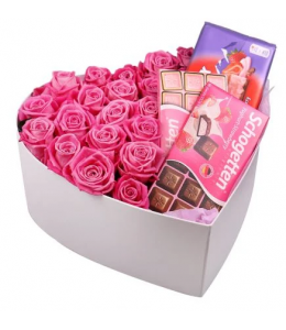 Roses in a heart with chocolates.