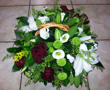 Arrangement in a basket with white and red roses oriental